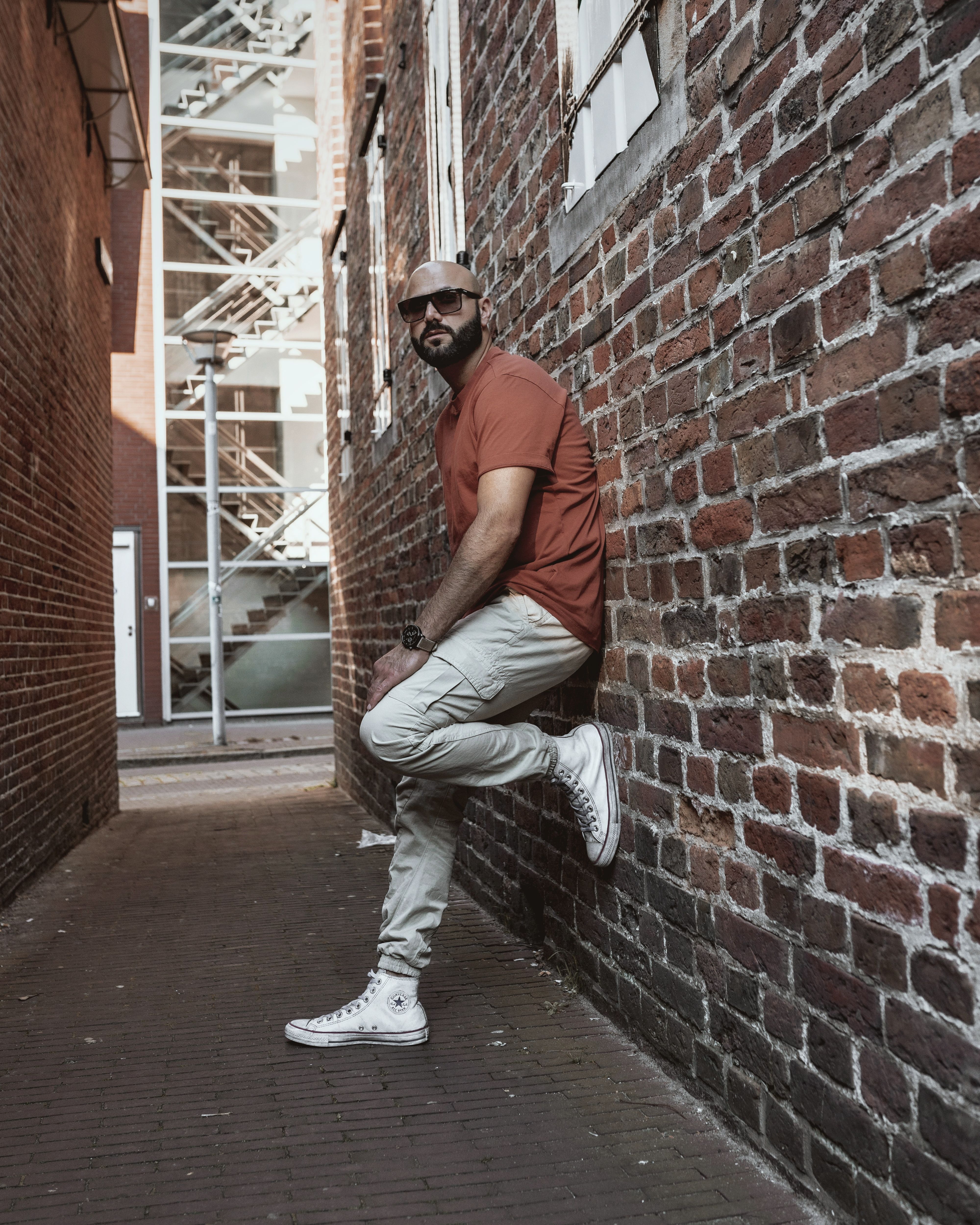 Man Leaning on a Brick Wall · Free Stock Photo