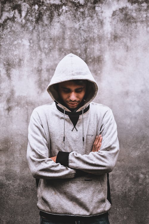 A Man Looking Down while Wearing a Hoodie · Free Stock Photo
