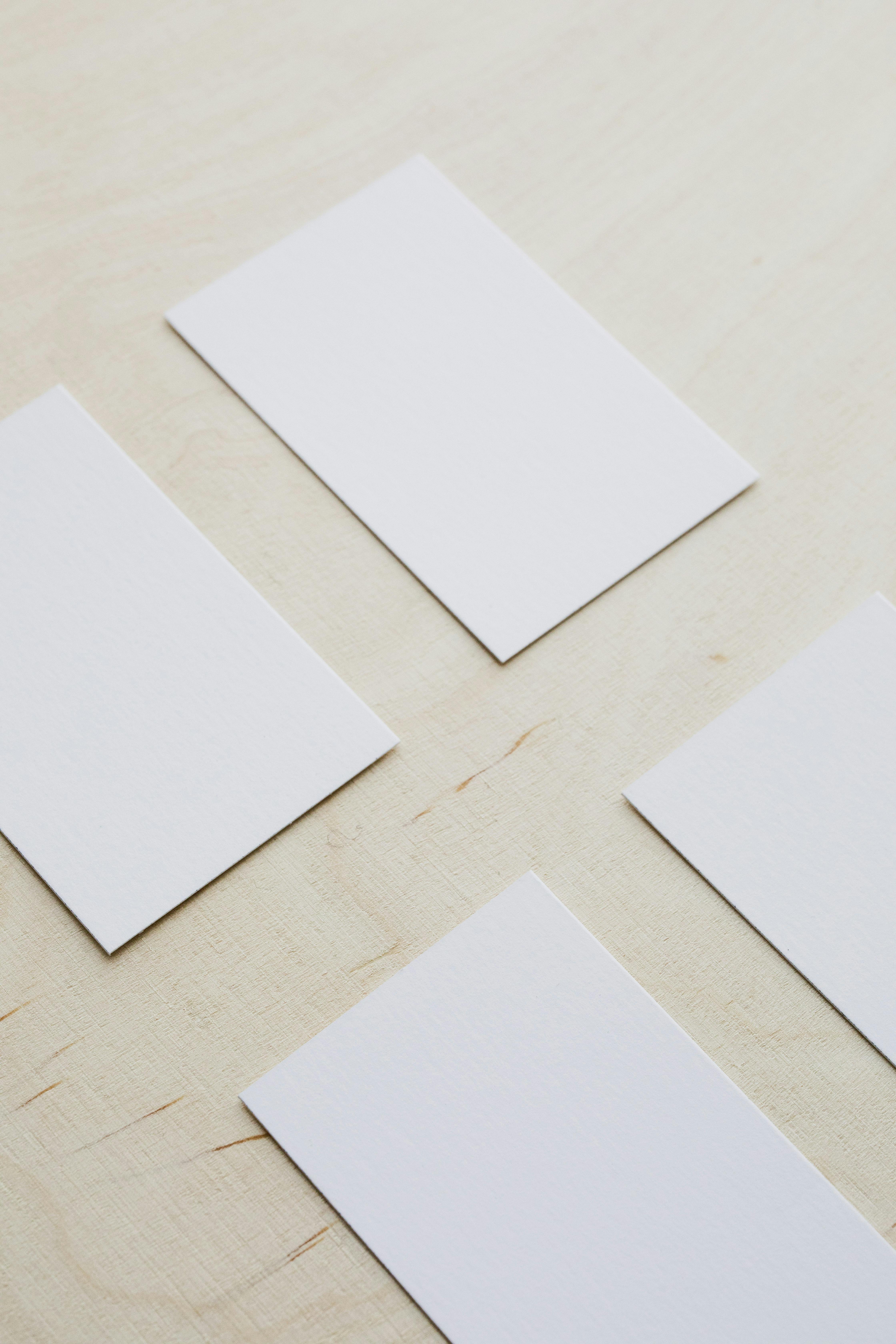 set of white blank business cards on wooden table