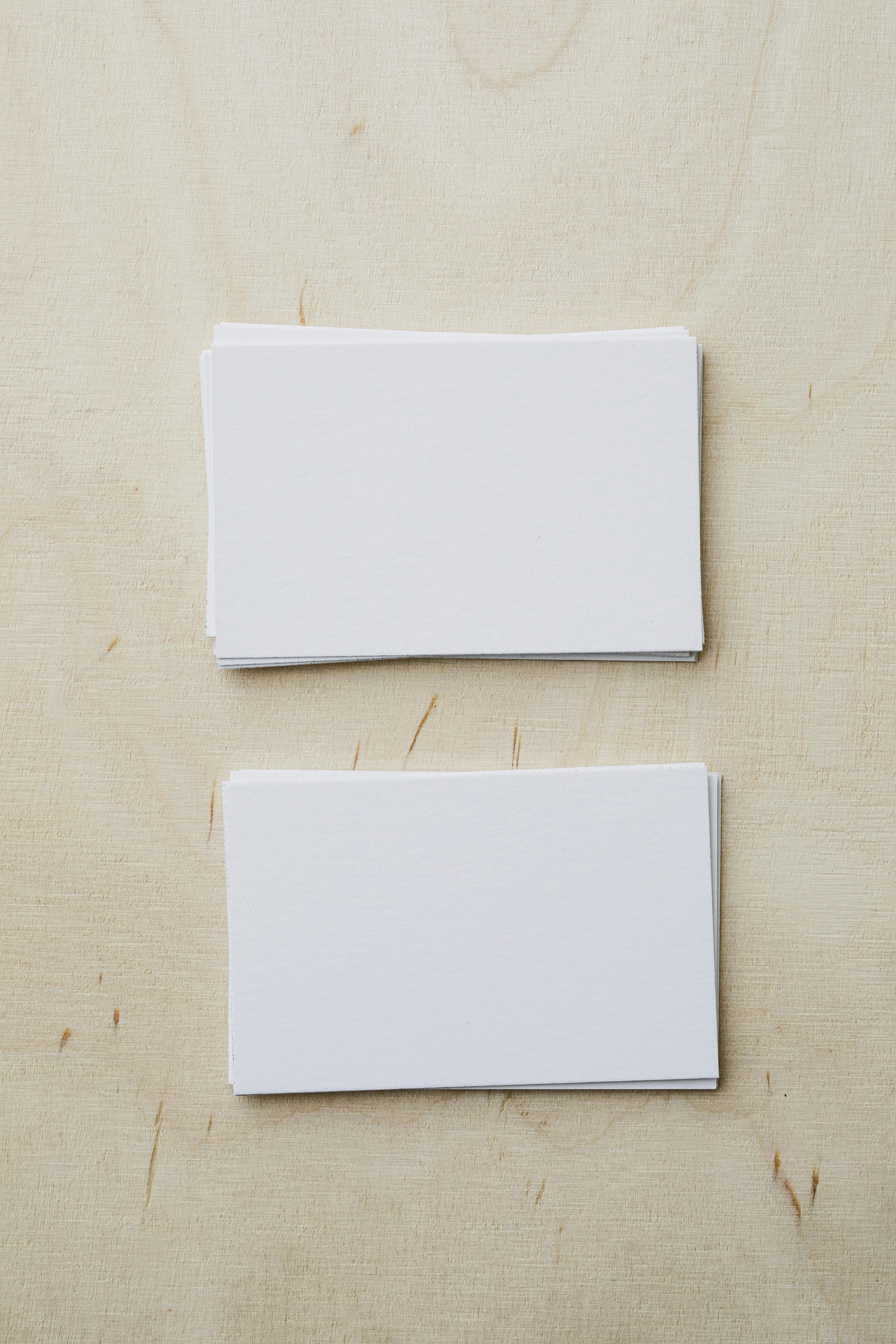 stacks of blank white visiting cards on table