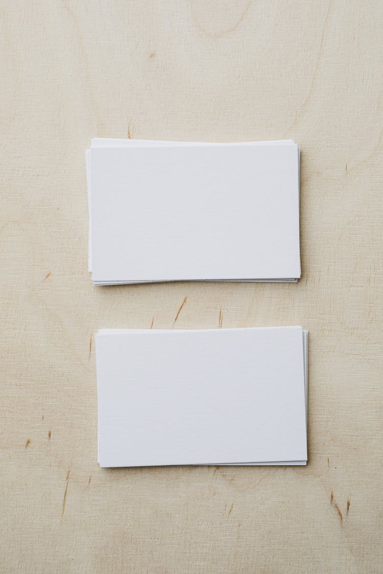 Stacks Of Blank White Visiting Cards On Table