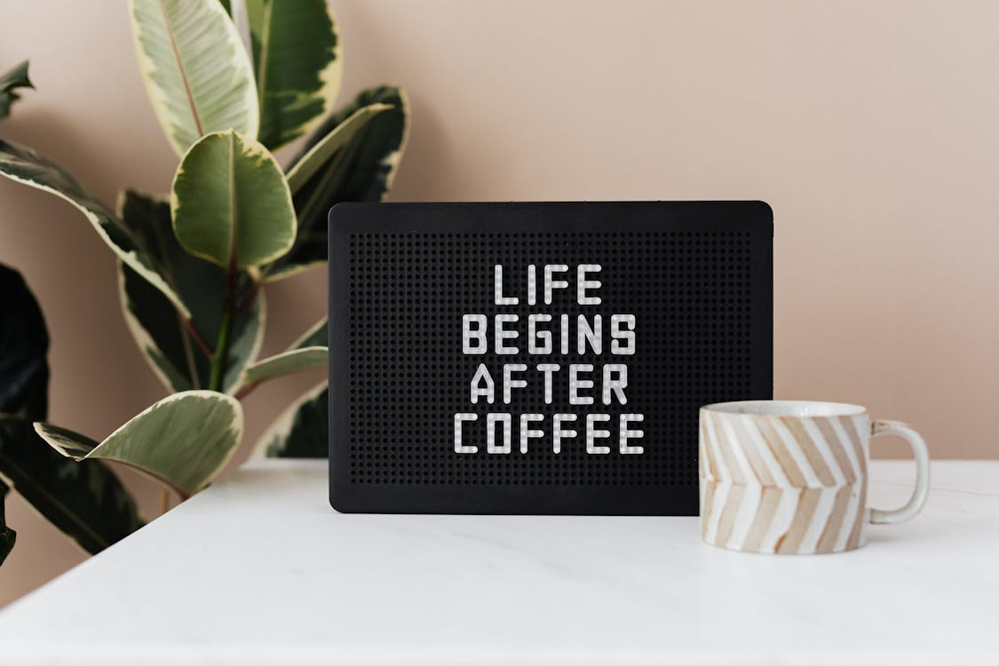 Free Message board with funny motto and cup of coffee Stock Photo