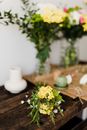 Fresh bouquet placed on wooden table for pruning