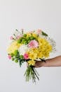 Crop man with big bouquet in hand