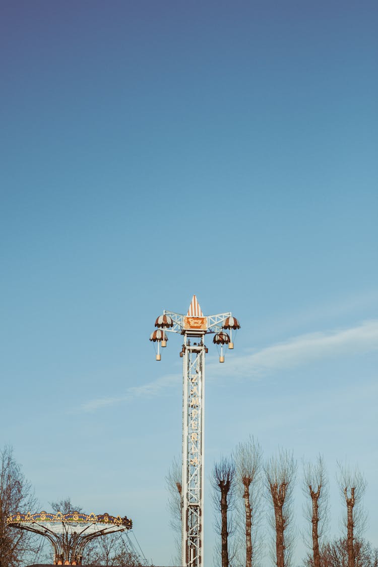 Tall Ride At Amusement Park Under Blue Sky