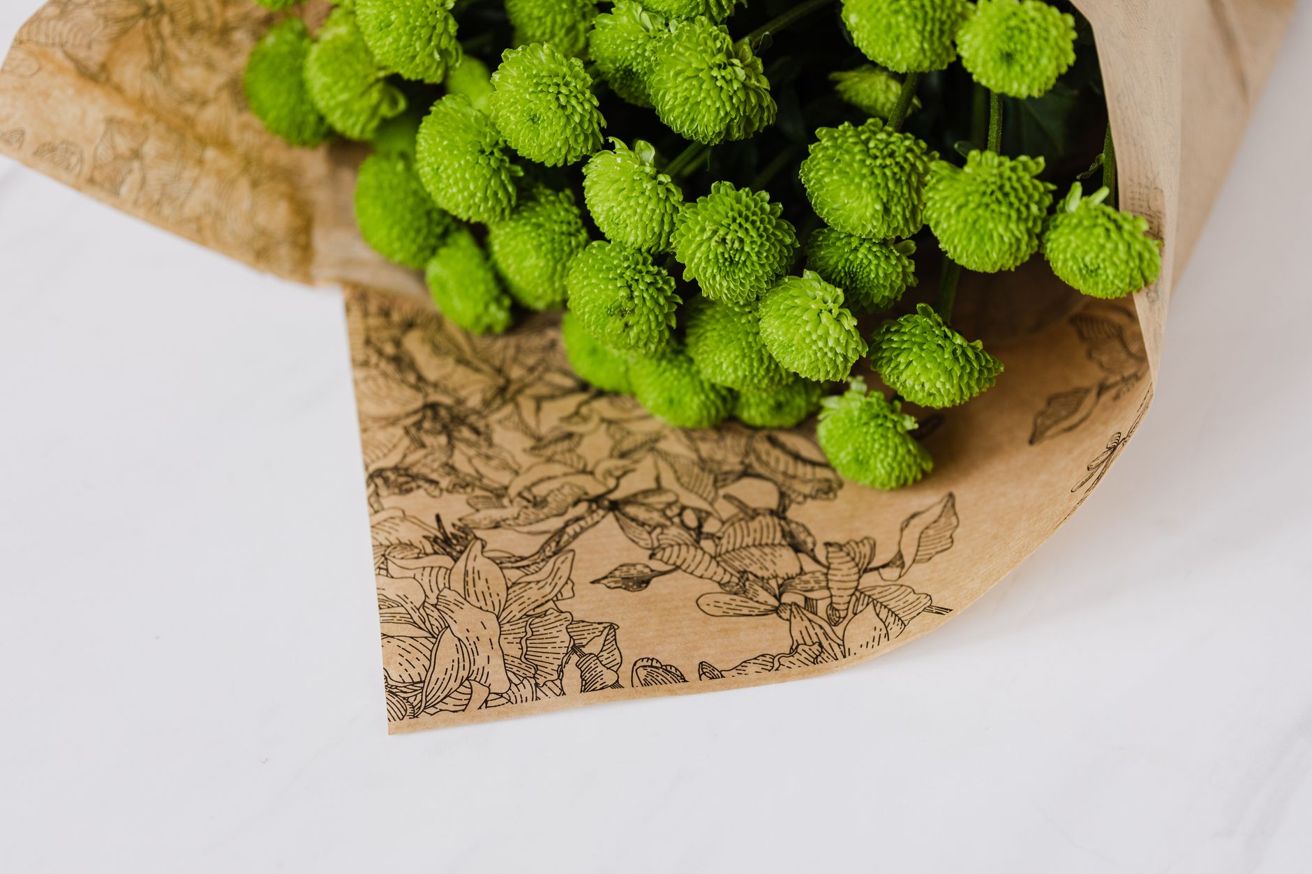 Bouquet of craspedia wrapped in flower paper packaging
