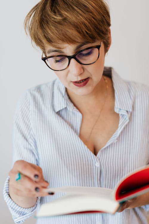 Crop positive woman with interesting book