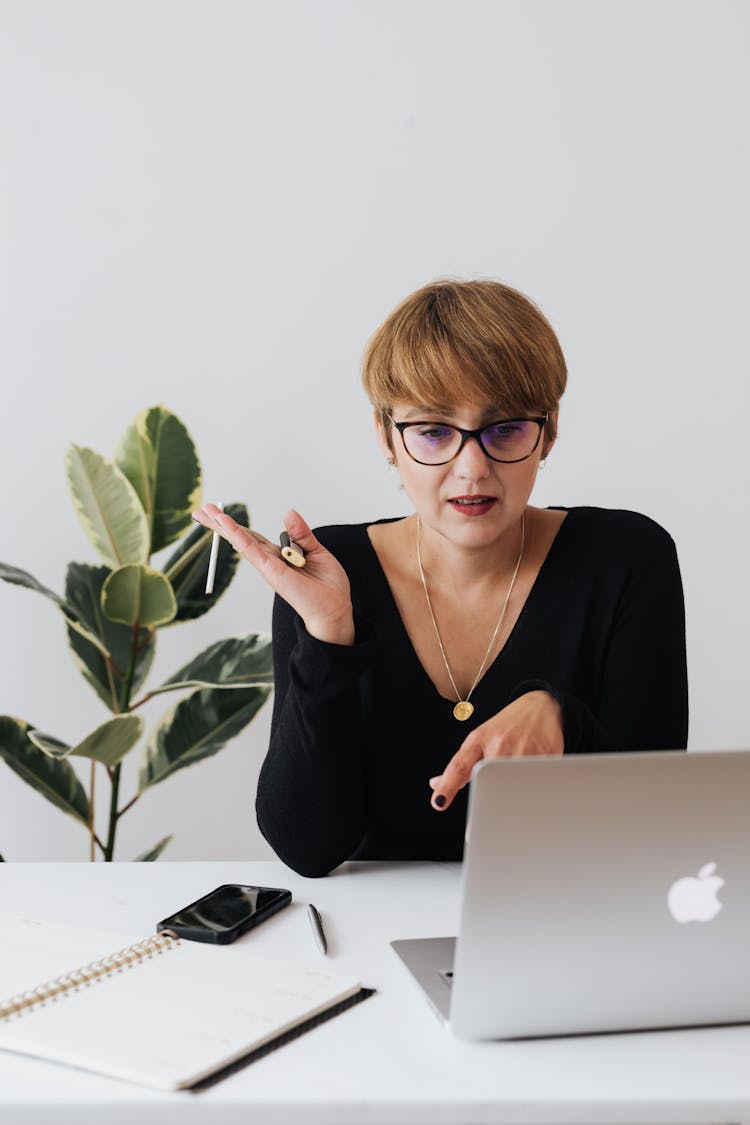 Serious Businesswoman Having Video Call Via Laptop