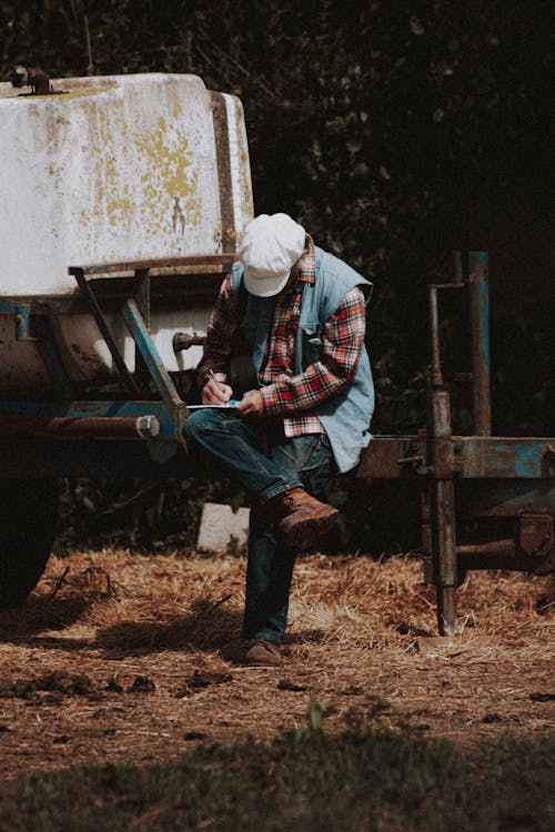 Unrecognizable farmer making notes during break