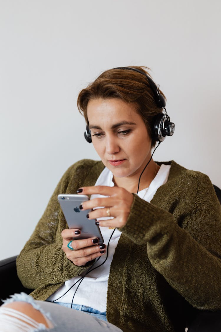 Positive Woman Using Smartphone And Headphones