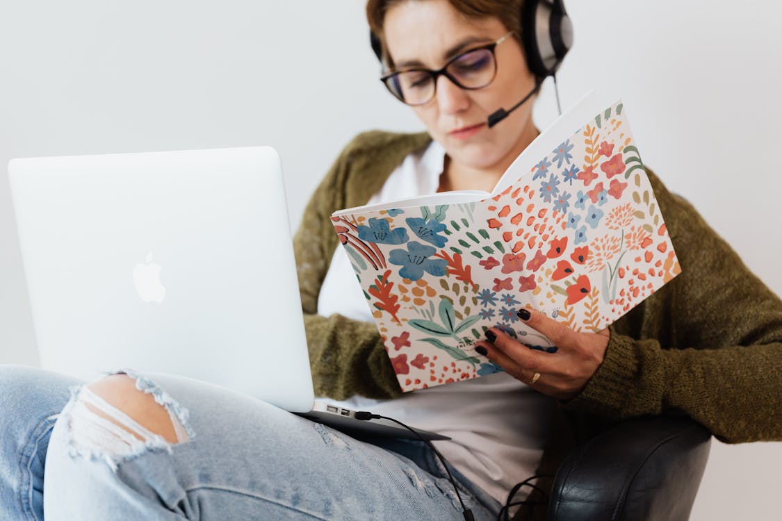 A Woman Working while Holding Her Notebook