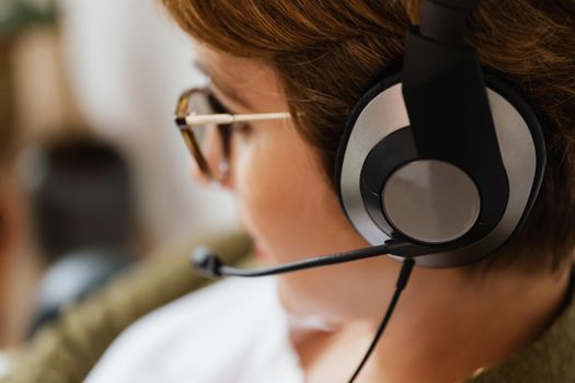 A close-up shot of a person wearing headphones, focusing on telecommuting through technology.