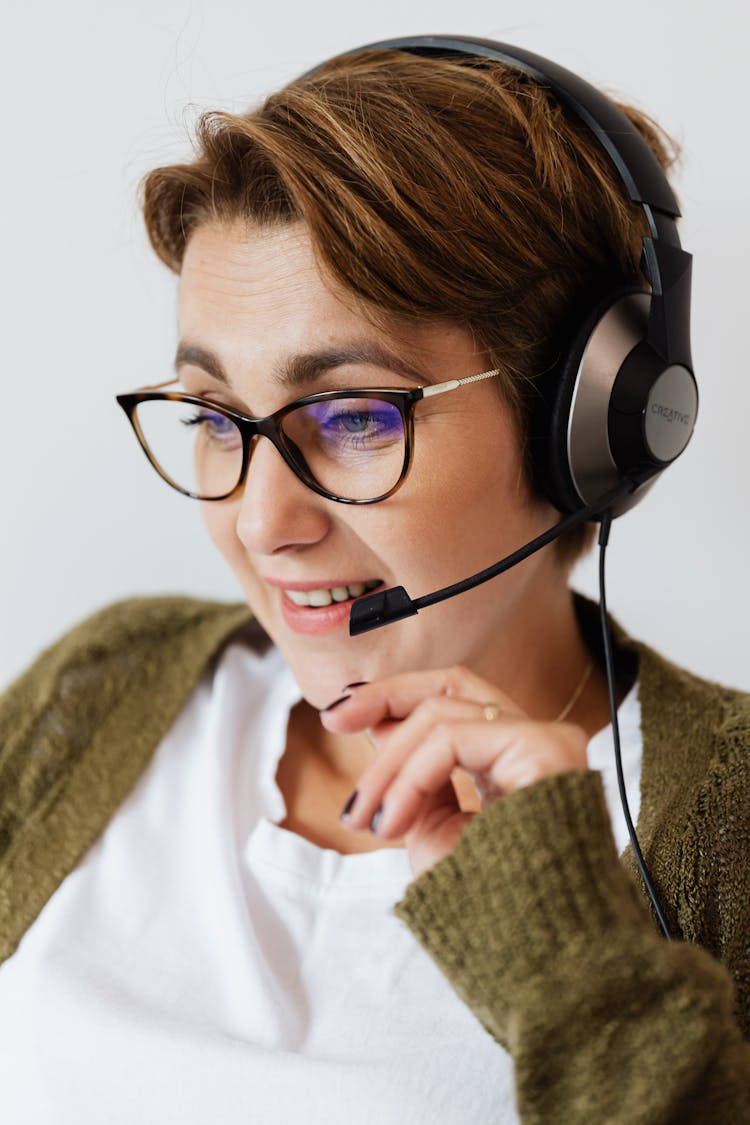 Adolescent Nice Woman In Eyeglasses With Headphones