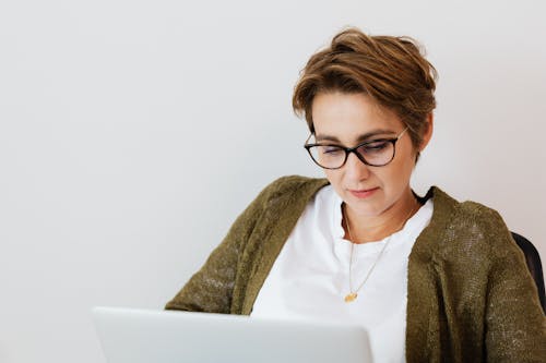 Positive businesswoman using netbook in modern workspace