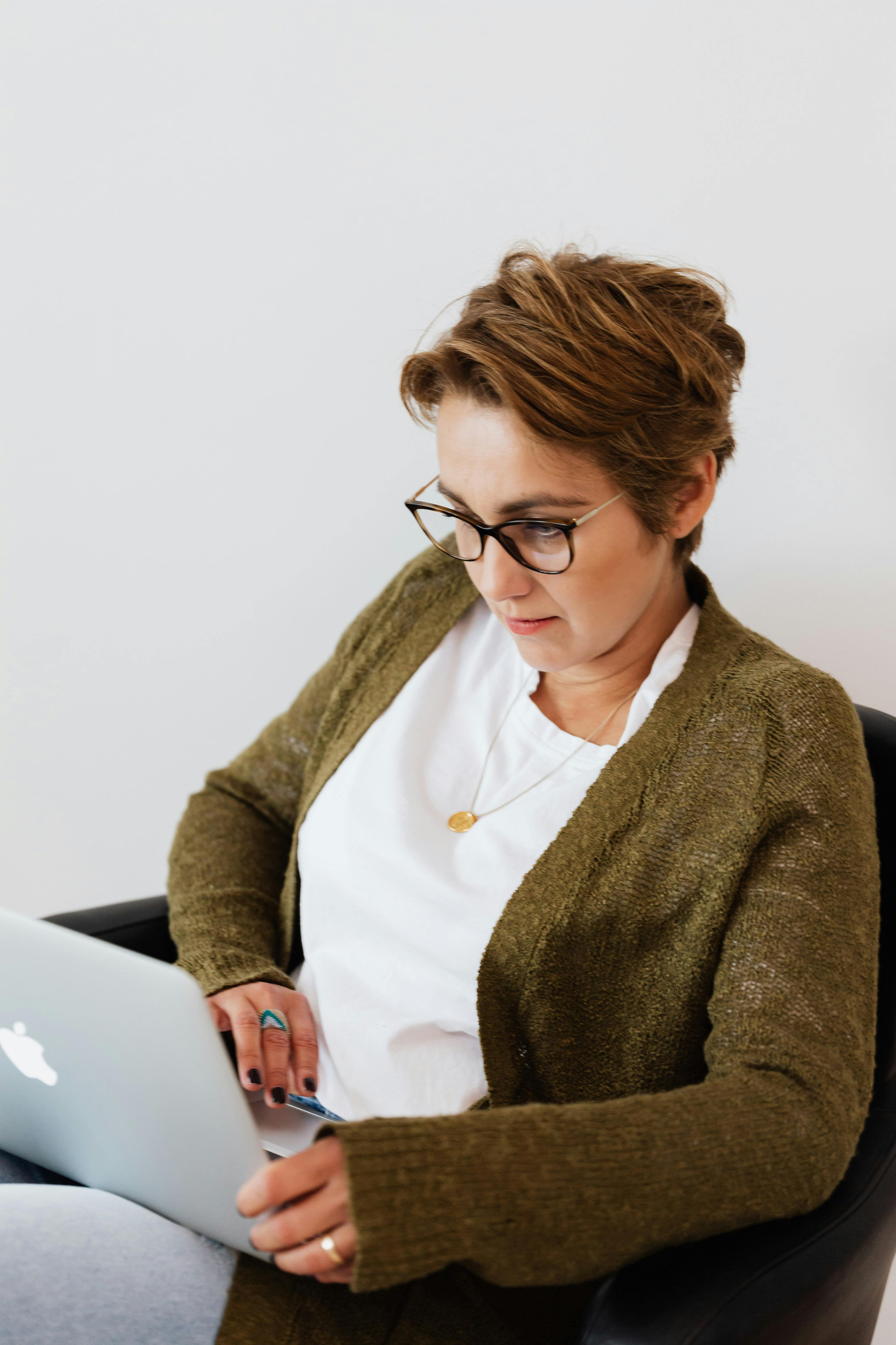 pensive lady watching movie on laptop at home