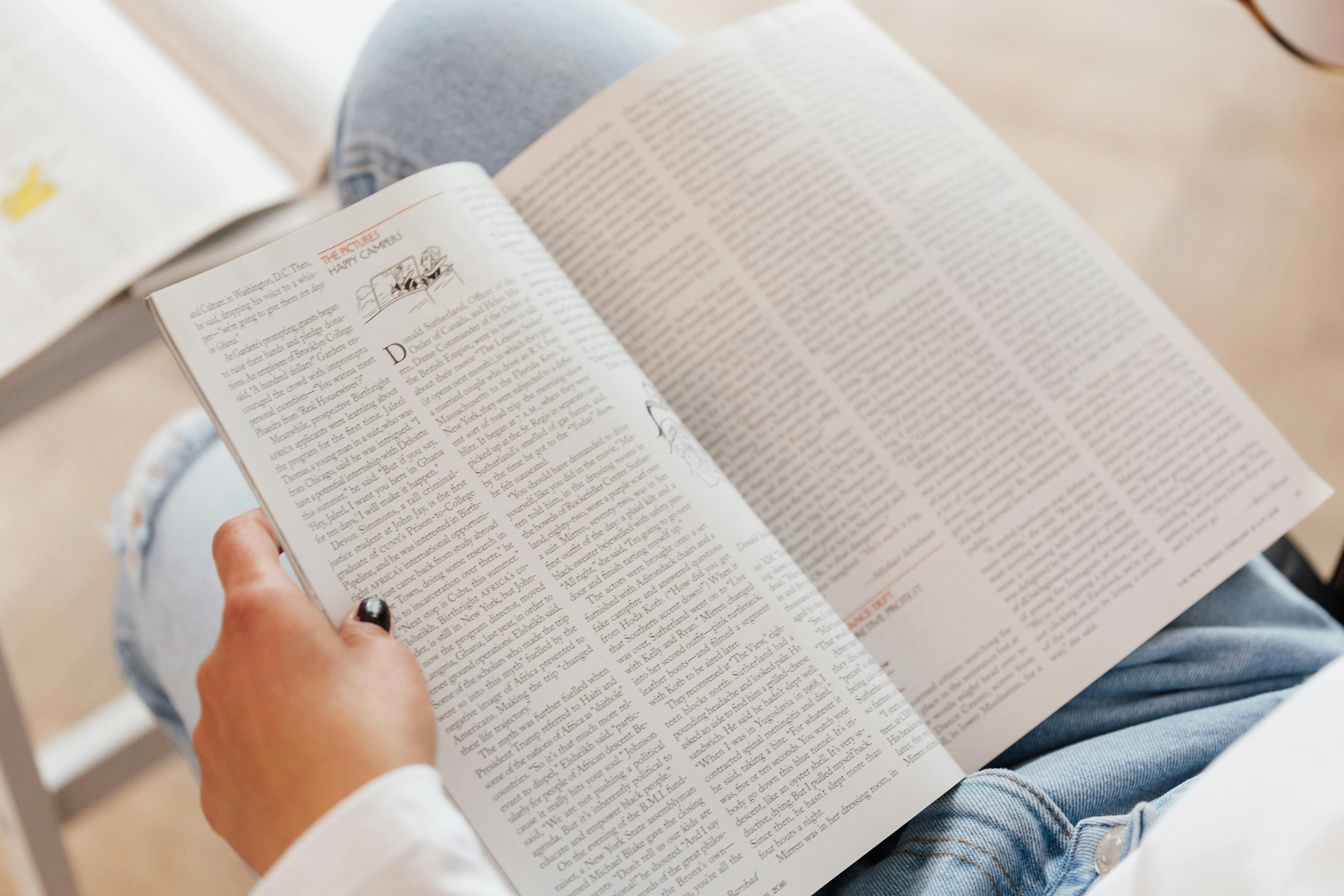 crop unrecognizable woman with opened magazine