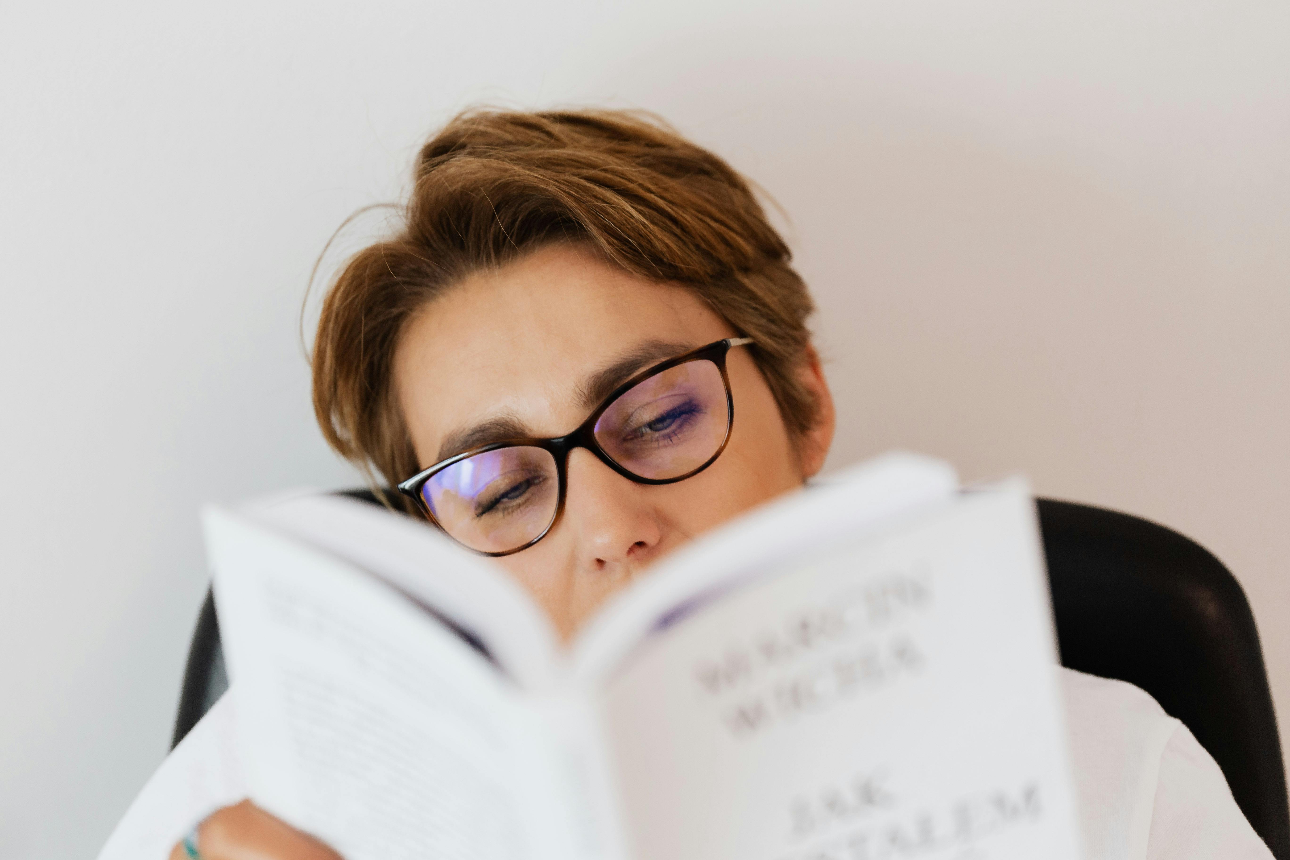 young woman reading book at home