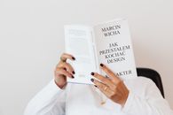 Faceless woman immersed in reading book
