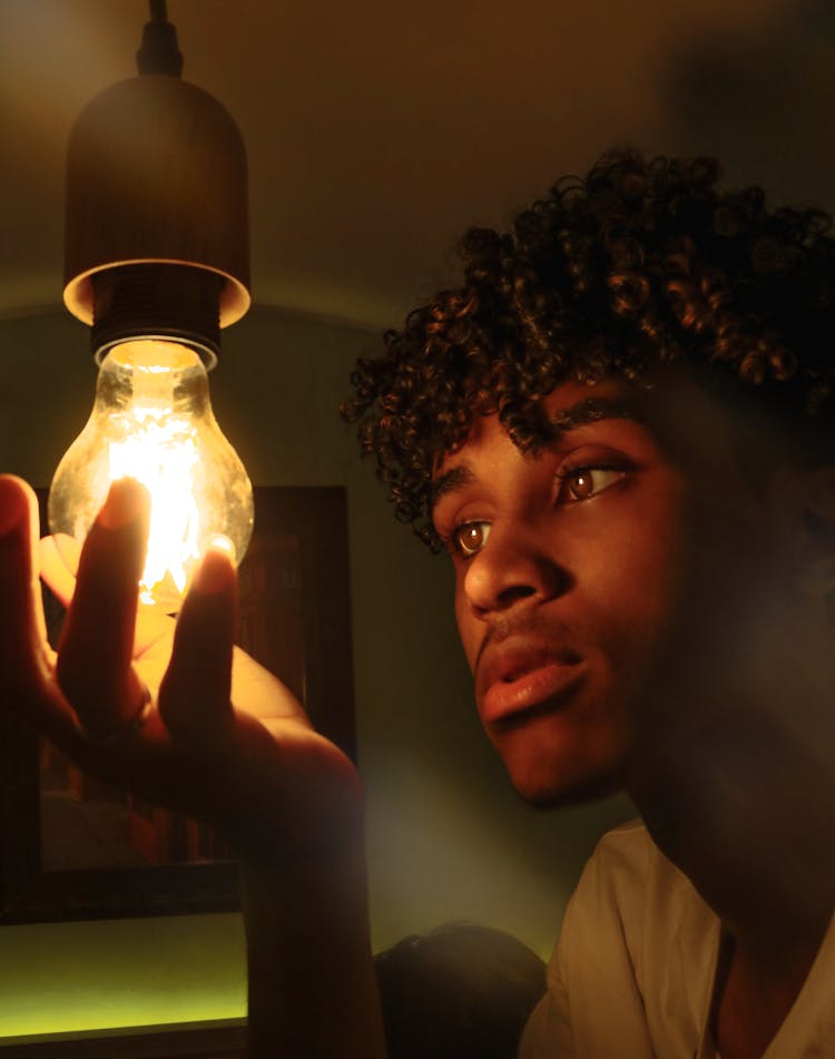 Black Man Changing Light Bulb