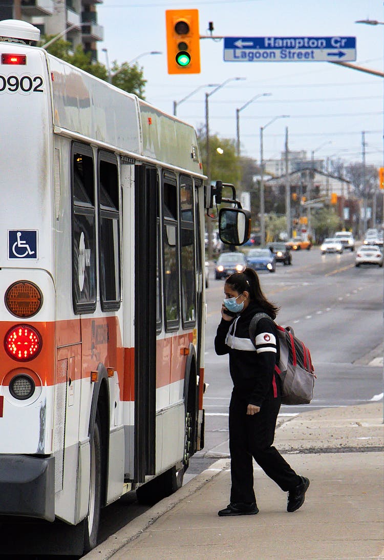 Woman In Mask Entering Bus