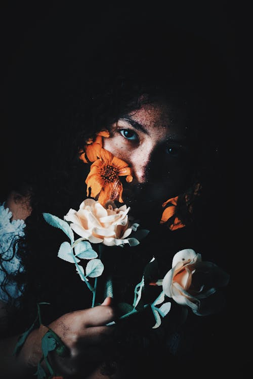 Young woman smelling natural flowers
