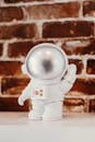 White Astronaut Toy on the Table