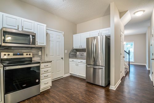 Free Bright modern kitchen featuring stainless steel appliances and white cabinets. Stock Photo