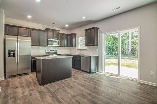 Free Spacious modern kitchen with stainless steel appliances and wooden floors. Stock Photo