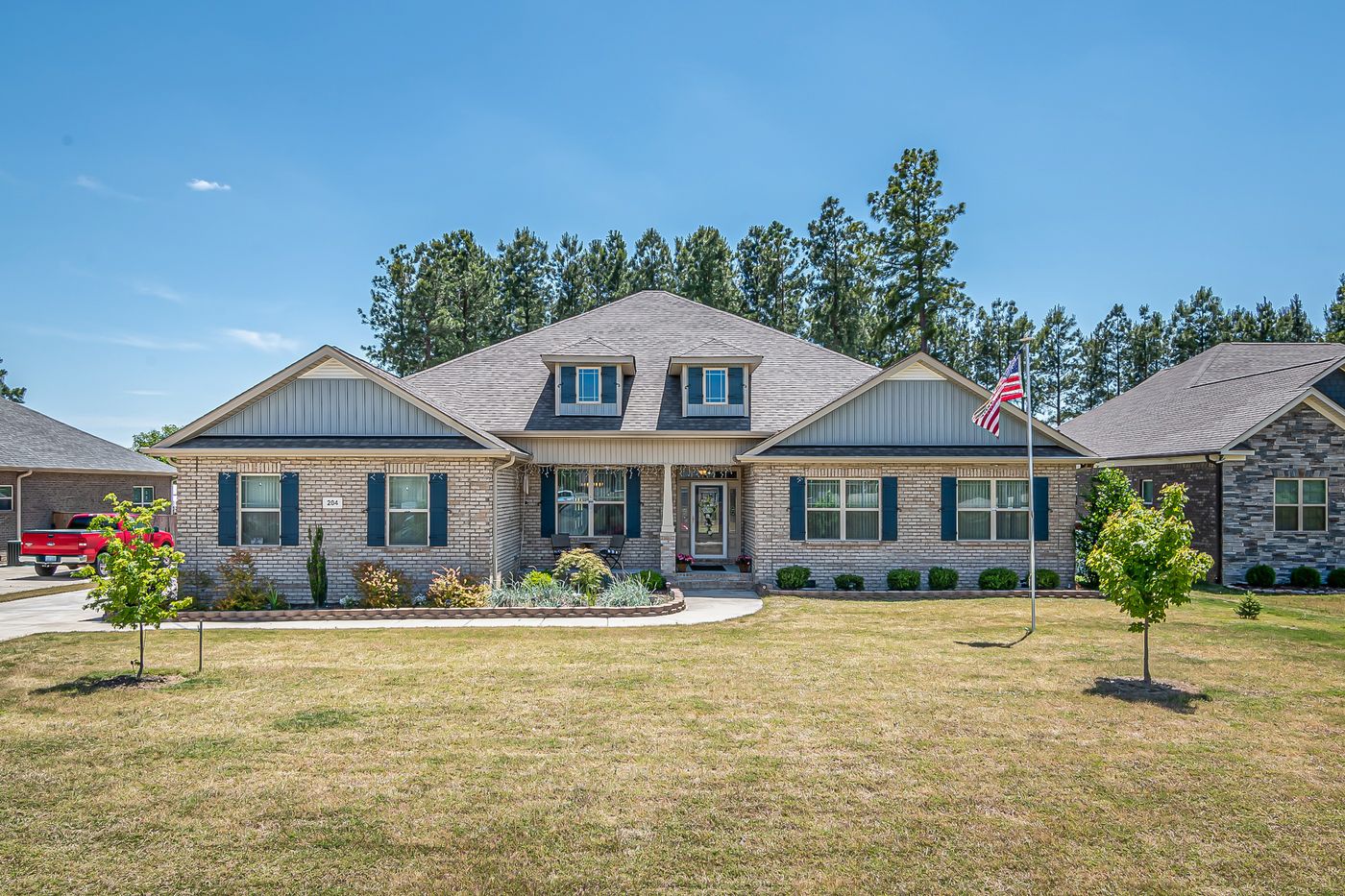 Single story brick and stone home with shingle roof