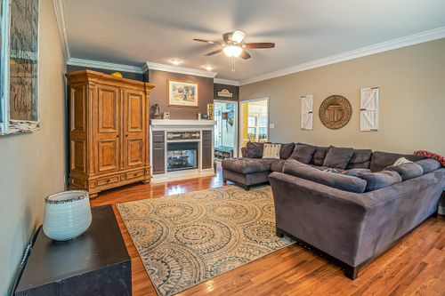 Free Spacious living room featuring vintage furniture, a fireplace, and elegant decor for a warm atmosphere. Stock Photo