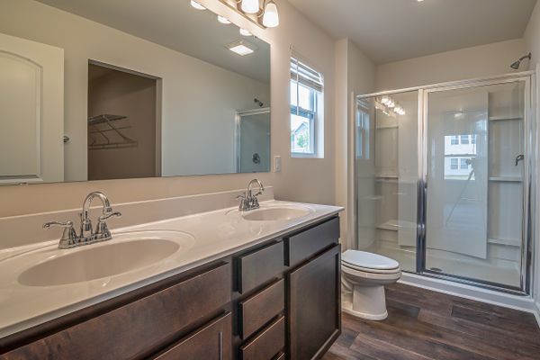 Spa-style bathroom remodel with walk-in shower and natural stone tile by Hinson Construction in North Myrtle Beach SC
