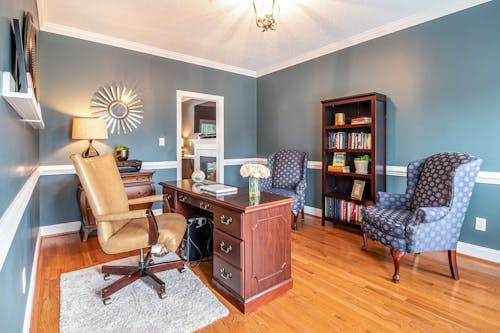 Brown Wooden Desk Beside Brown Armchair