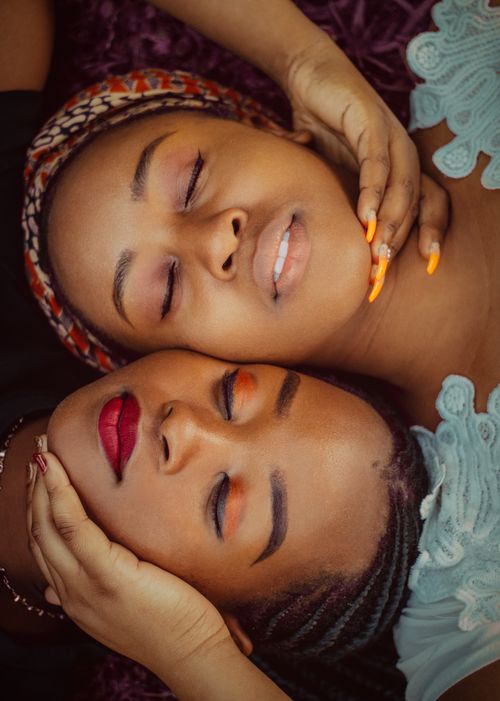 Free A close-up of two women with eyes closed, lying together intimately. Stock Photo