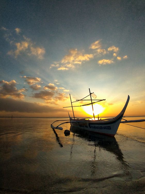 Photo of a Boat on a Shore at Sunset · Free Stock Photo
