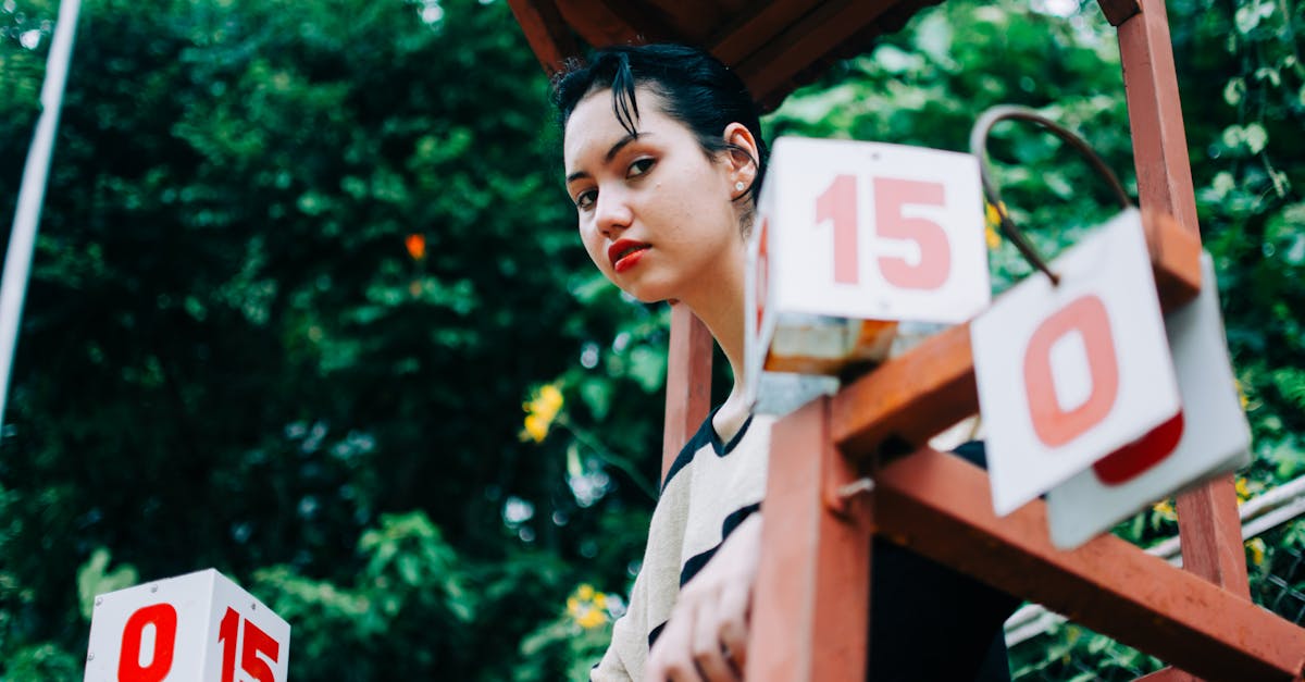 Low angle of serious female on chair with points for judge of tennis match