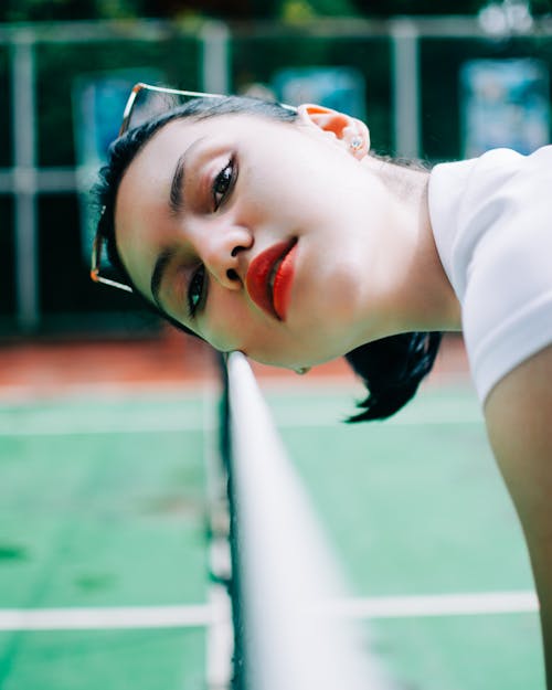 Confident young female athlete in tennis playground