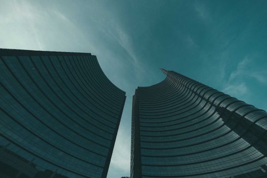 From below of contemporary skyscrapers with reflecting surface of walls in modern megapolis