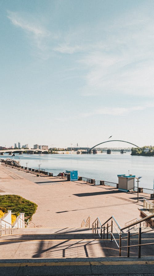 Stairs on embankment of river in sunny day