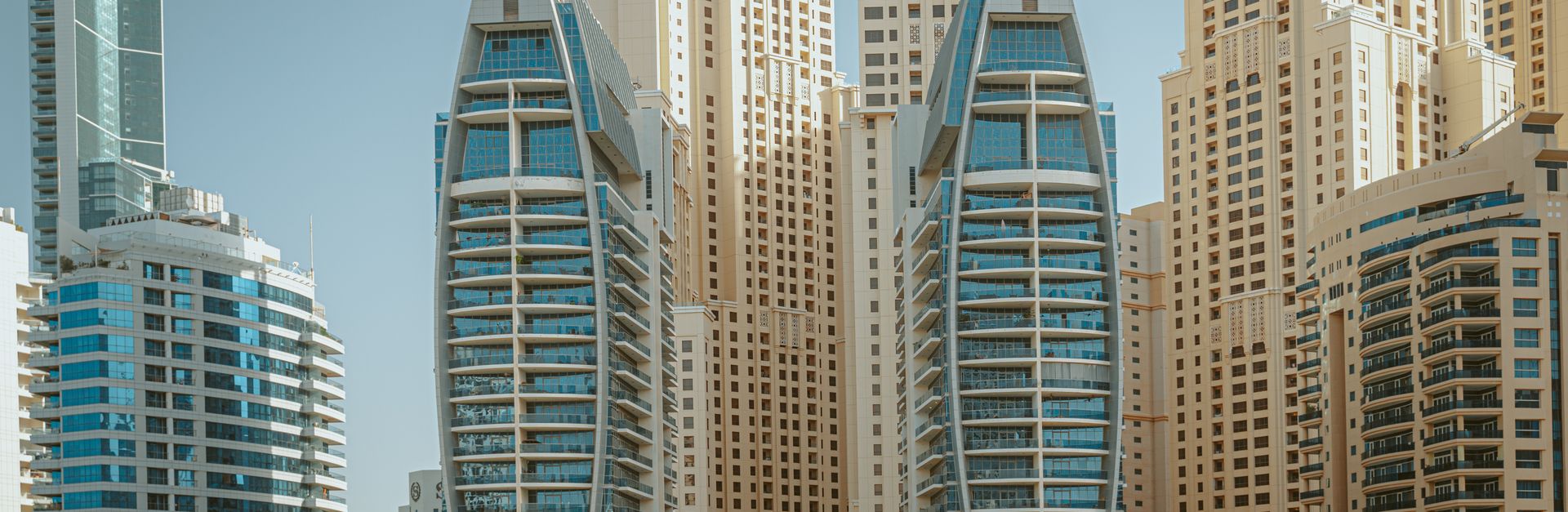 Stunning view of modern skyscrapers and yachts in Dubai Marina, UAE.