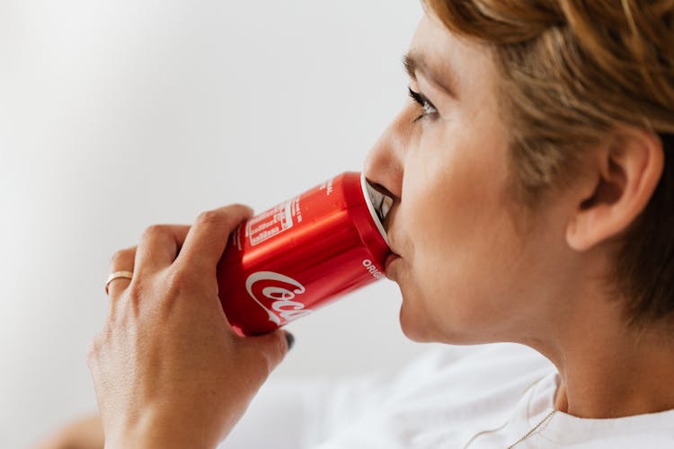 Crop Pensive Woman Drinking Refreshing Soda