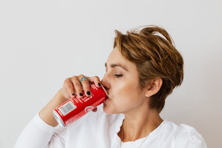 Thirsty Woman Enjoying Coke From Colorful Can