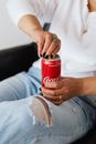 Crop faceless female opening can of coke
