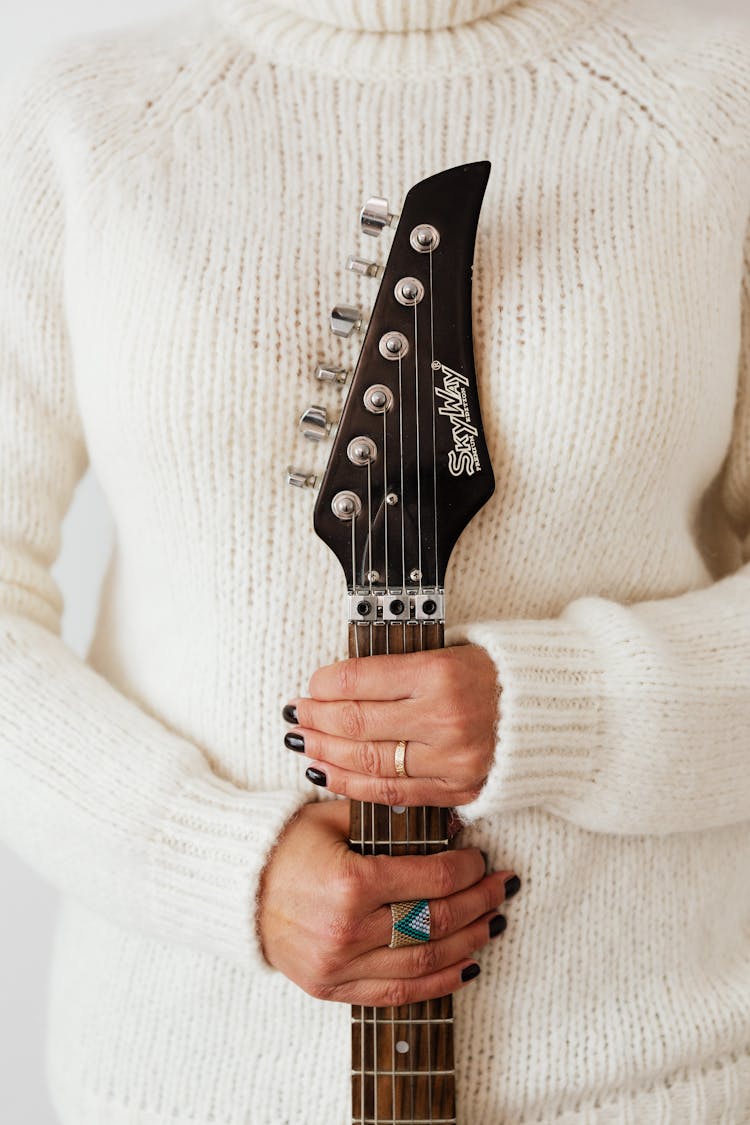 Crop Musician With Guitar Fretboard In Hands