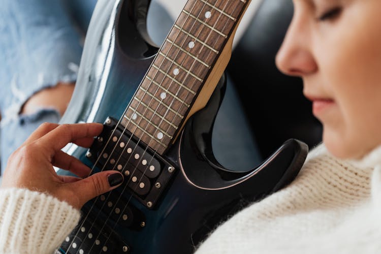 Crop Guitarist Playing Modern Electric Guitar