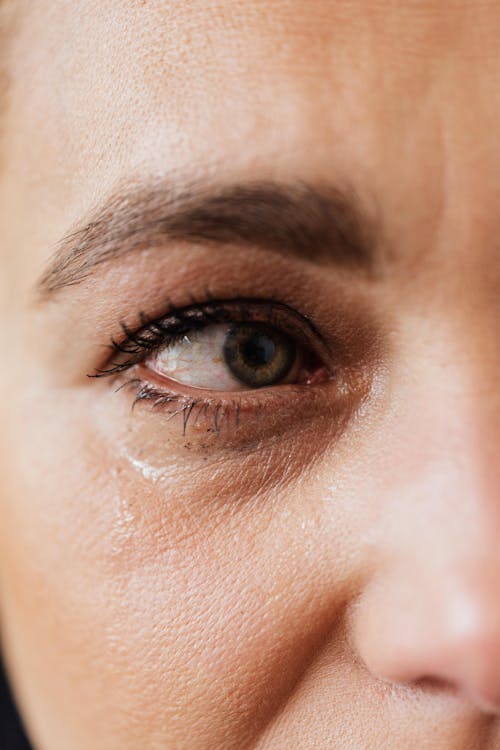 Tearful eye of upset middle aged woman