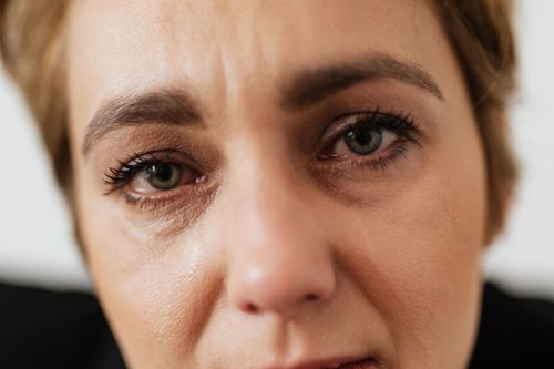Free Close-up portrait of a distressed woman showing emotion and vulnerability, emphasizing mental health themes. Stock Photo