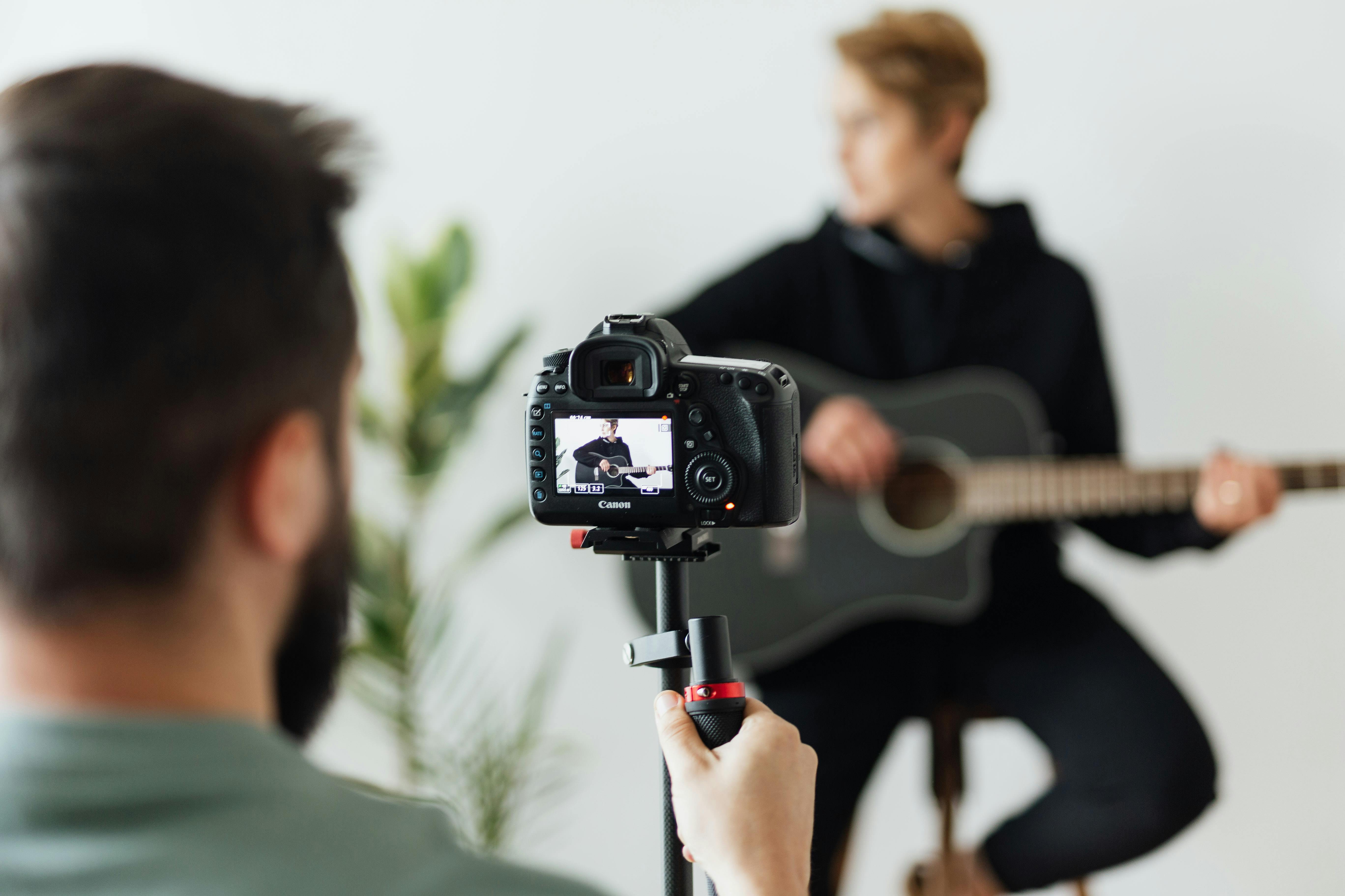 shallow focus photo of person taking picture using digital camera