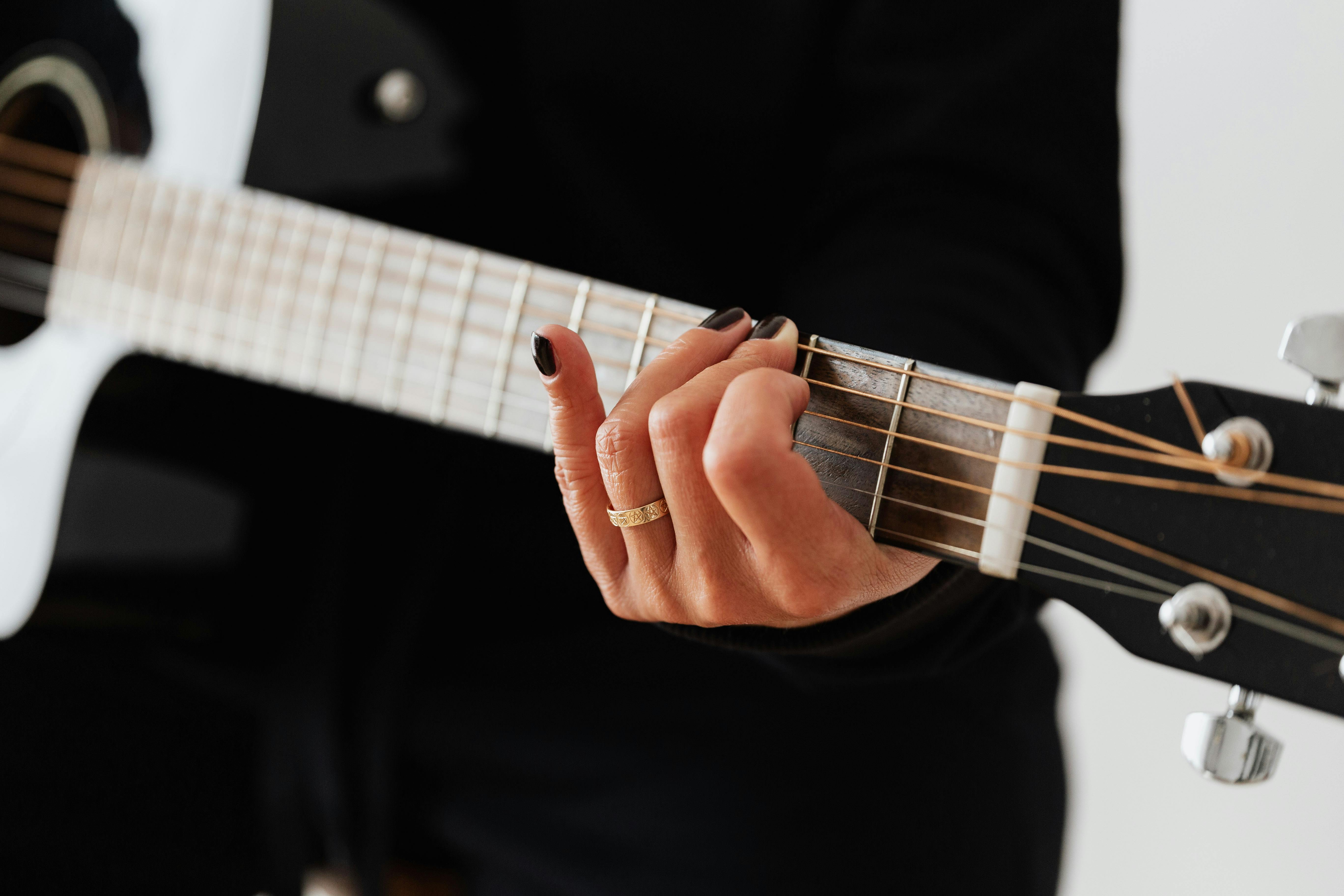 Person Playing Acoustic Guitar · Free Stock Photo
