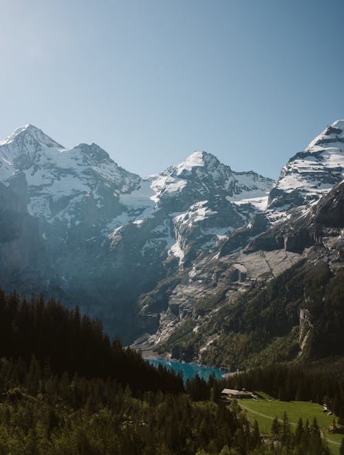 Free Mountain peaks with lake and green forest Stock Photo
