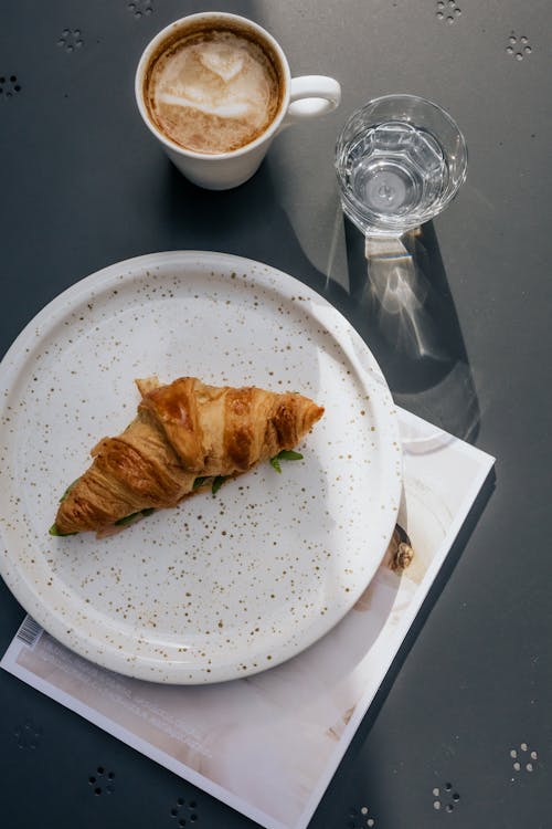 Free Top View of a Bread on a Plate beside a Mug and Glass Stock Photo